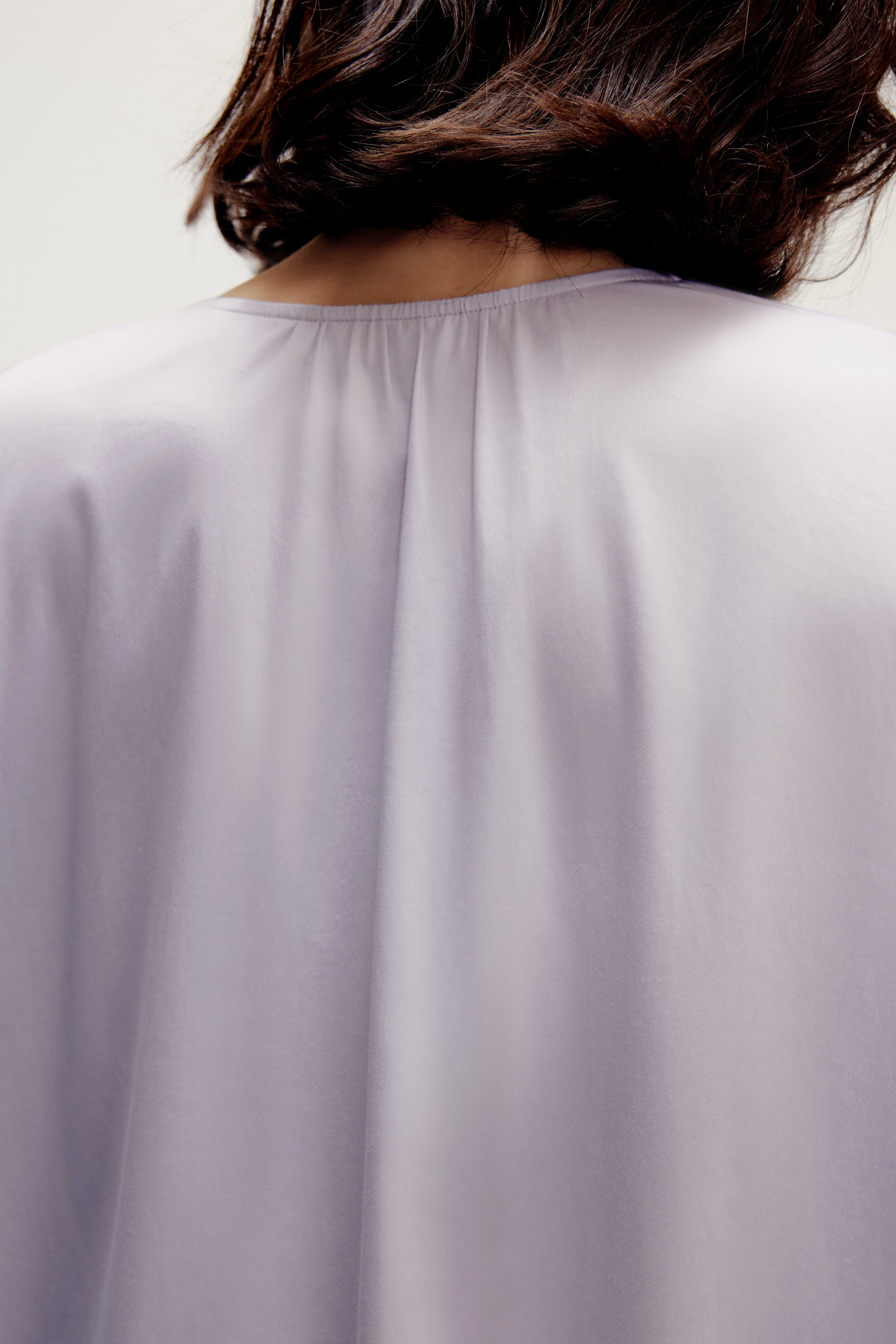 back of a woman wearing a purple pajama top