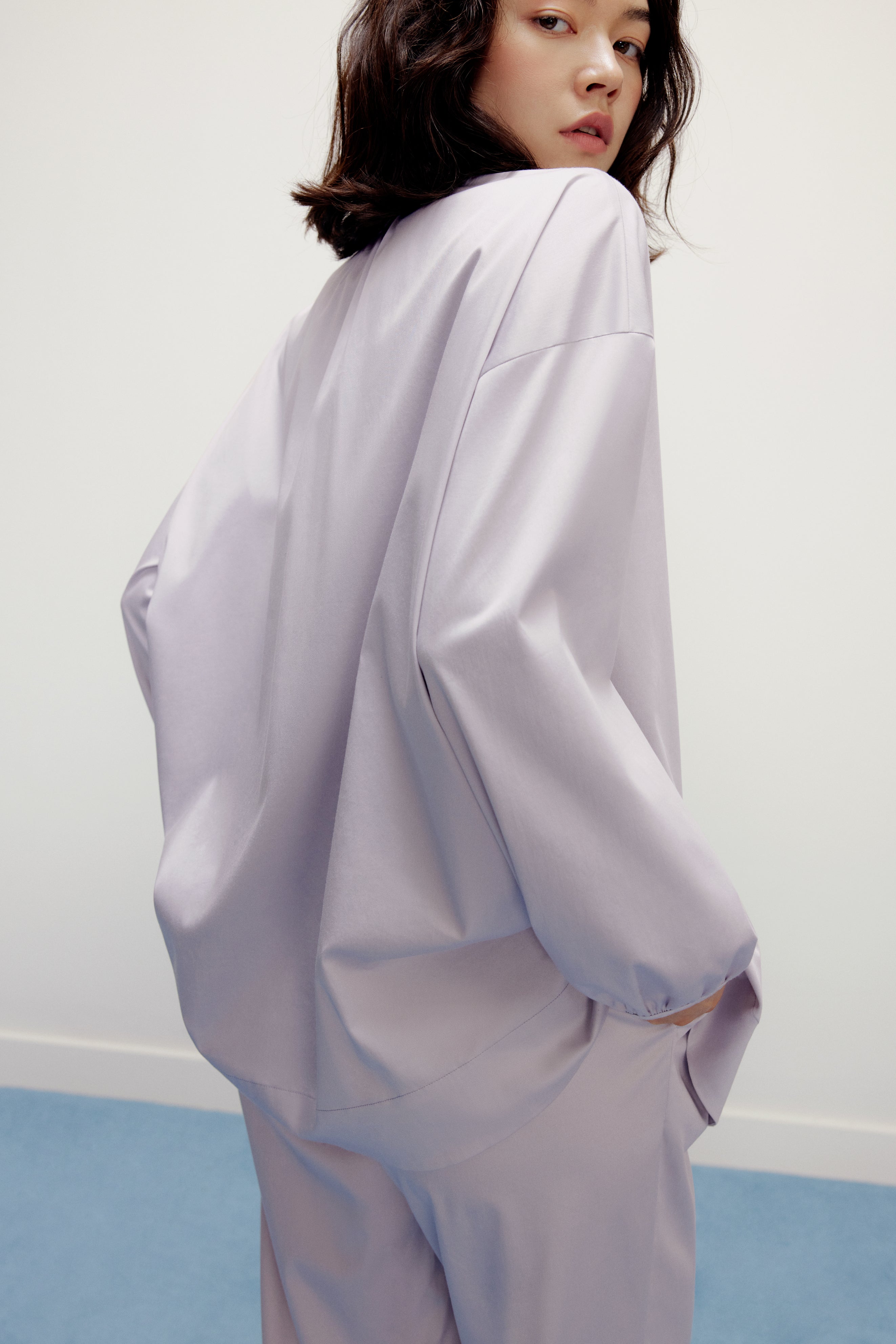 back of a woman wearing a purple pajama top