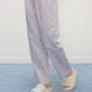 a person wearing a purple pants and white slippers