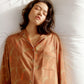 woman wearing button down brown color pajama top