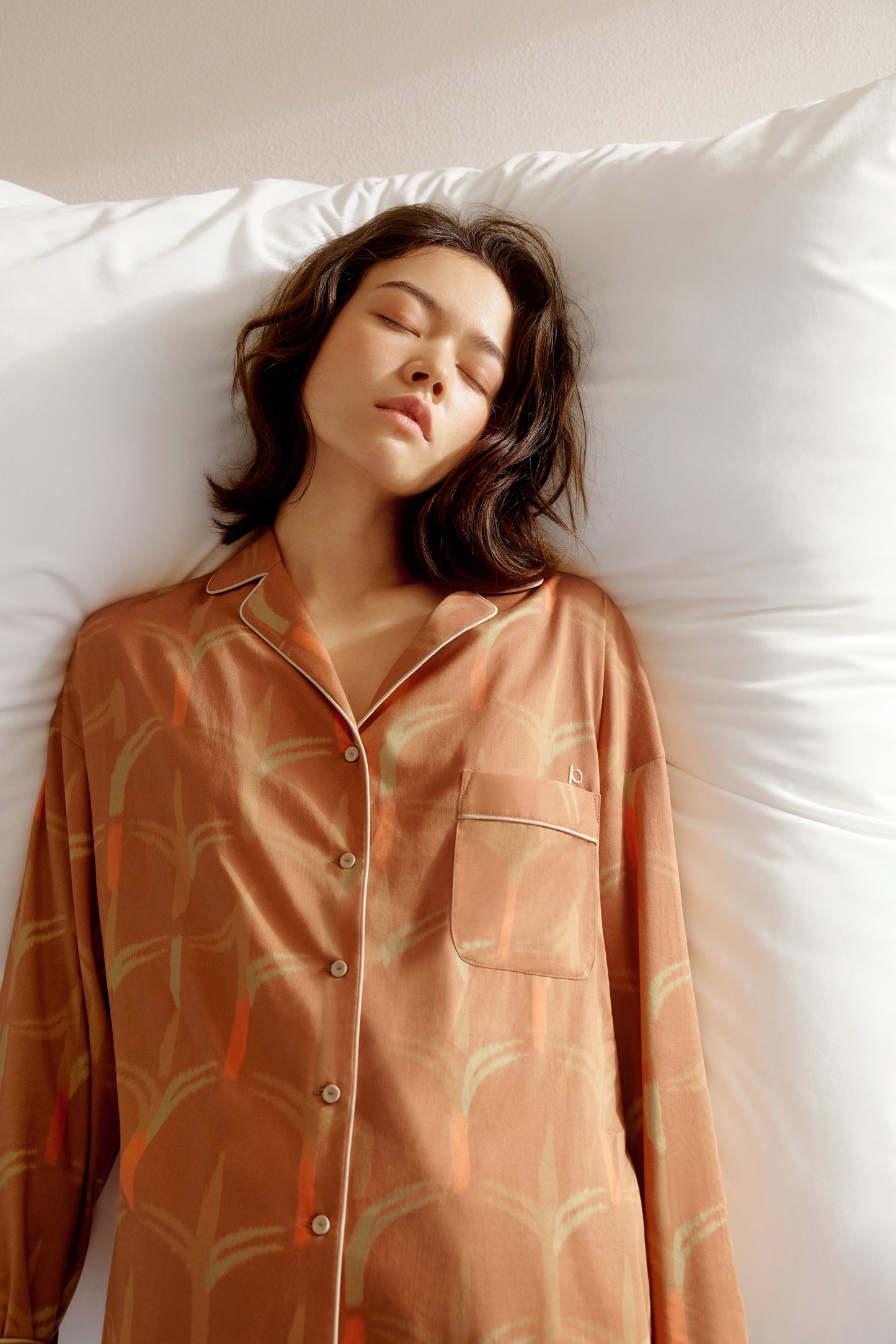 woman wearing button down brown color pajama top