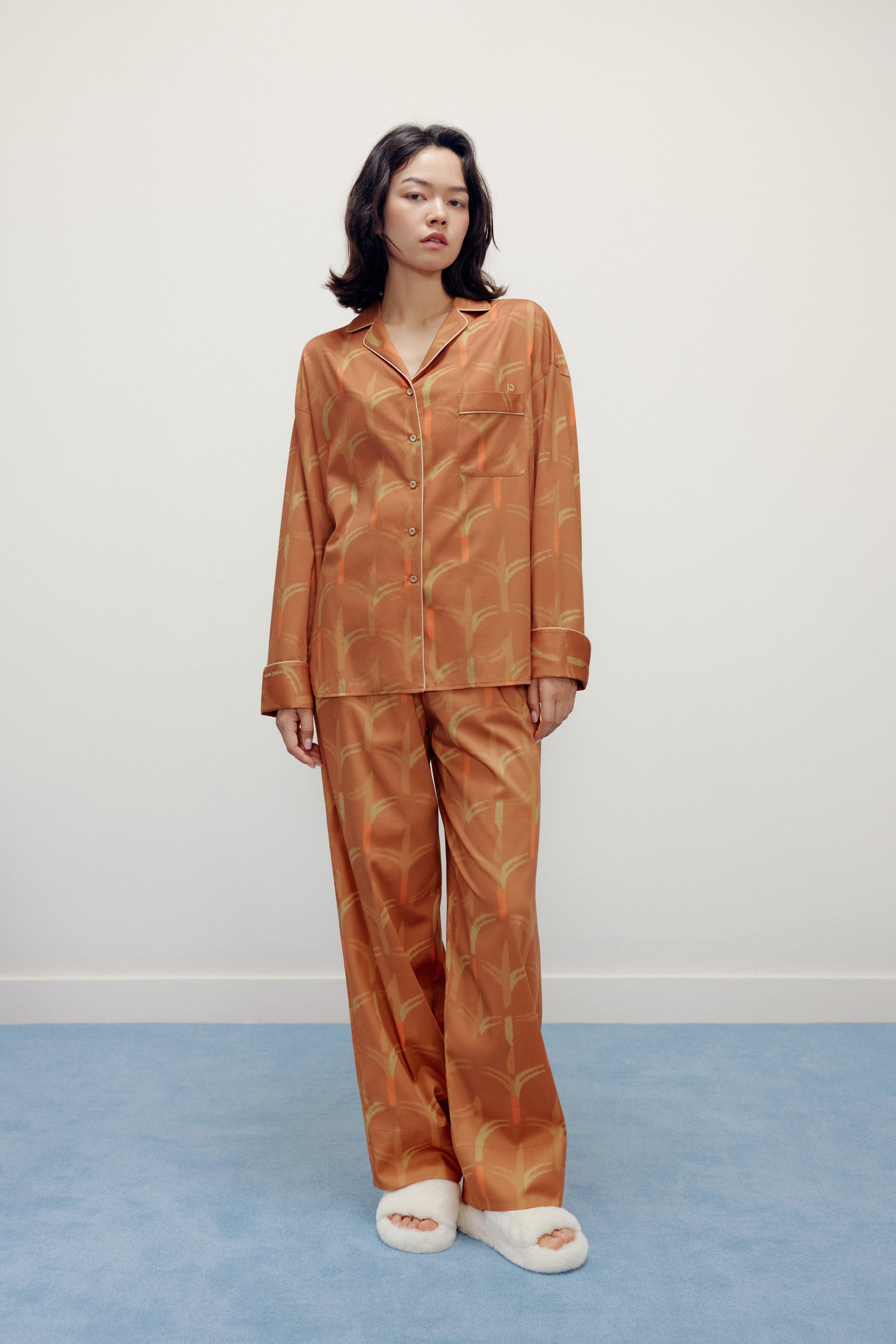 woman standing wearing brown pajama set