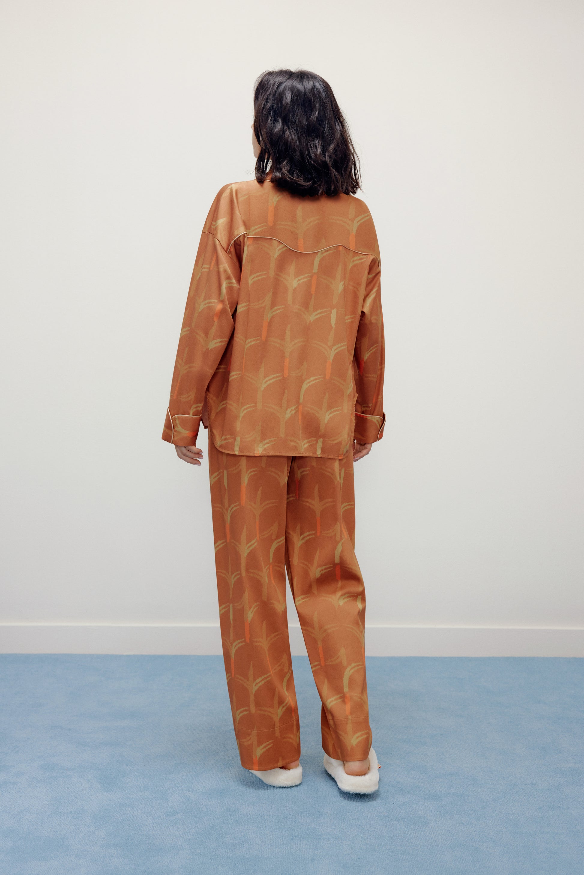 woman wearing brown pajama set from the back