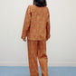 the back of woman standing wearing brown pajama set