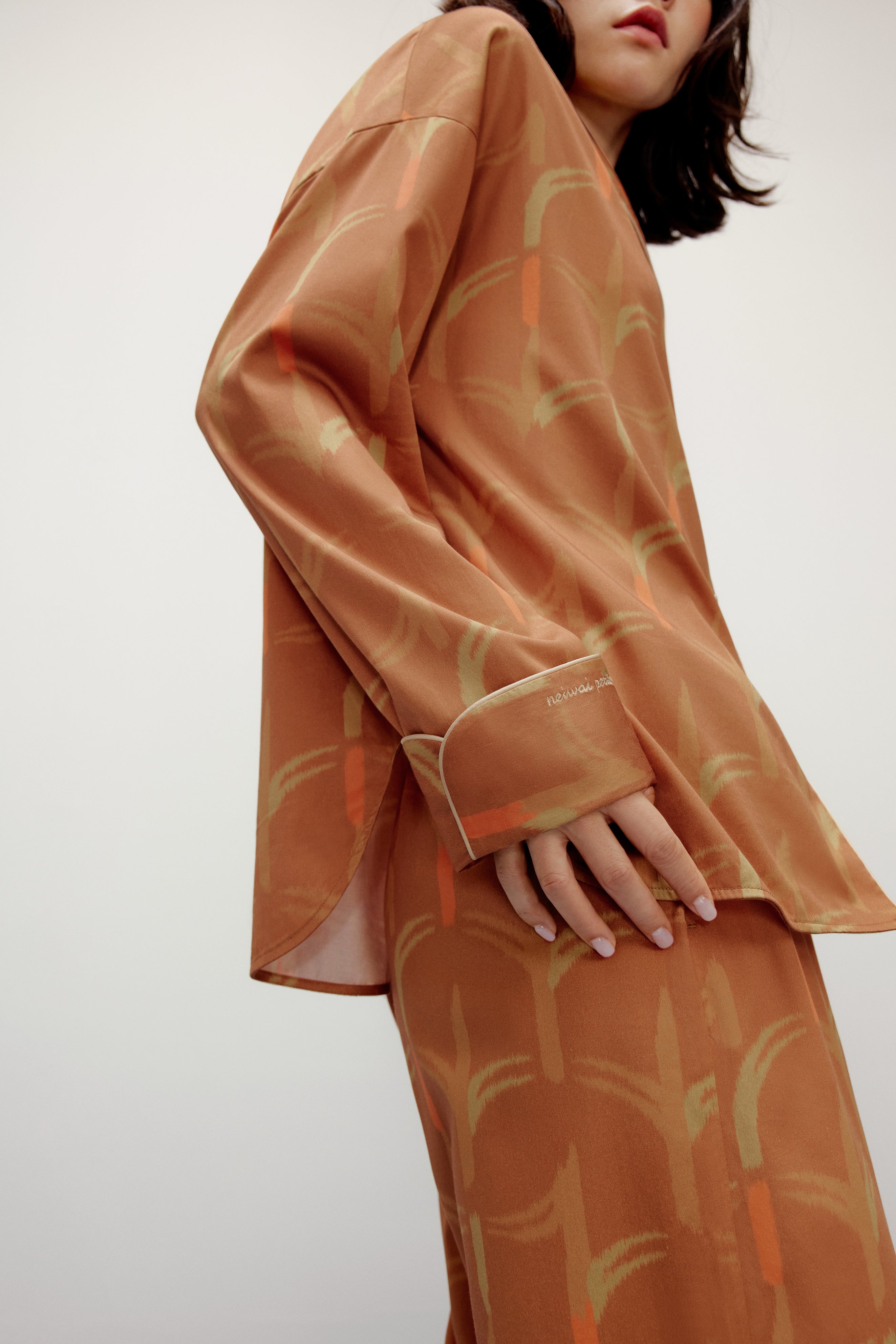 the side of woman wearing brown pajama set