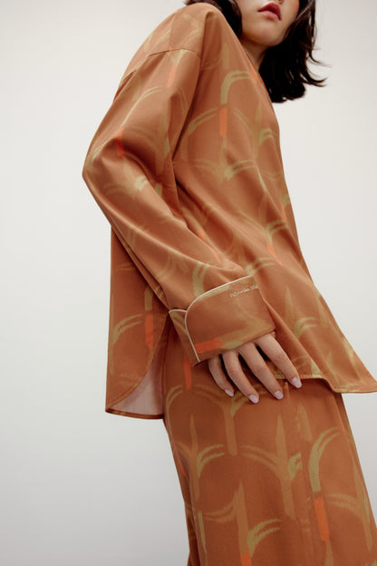 the side of woman wearing brown pajama set