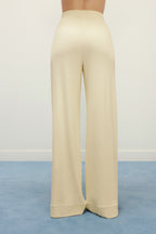 woman in yellow pajama pants from back