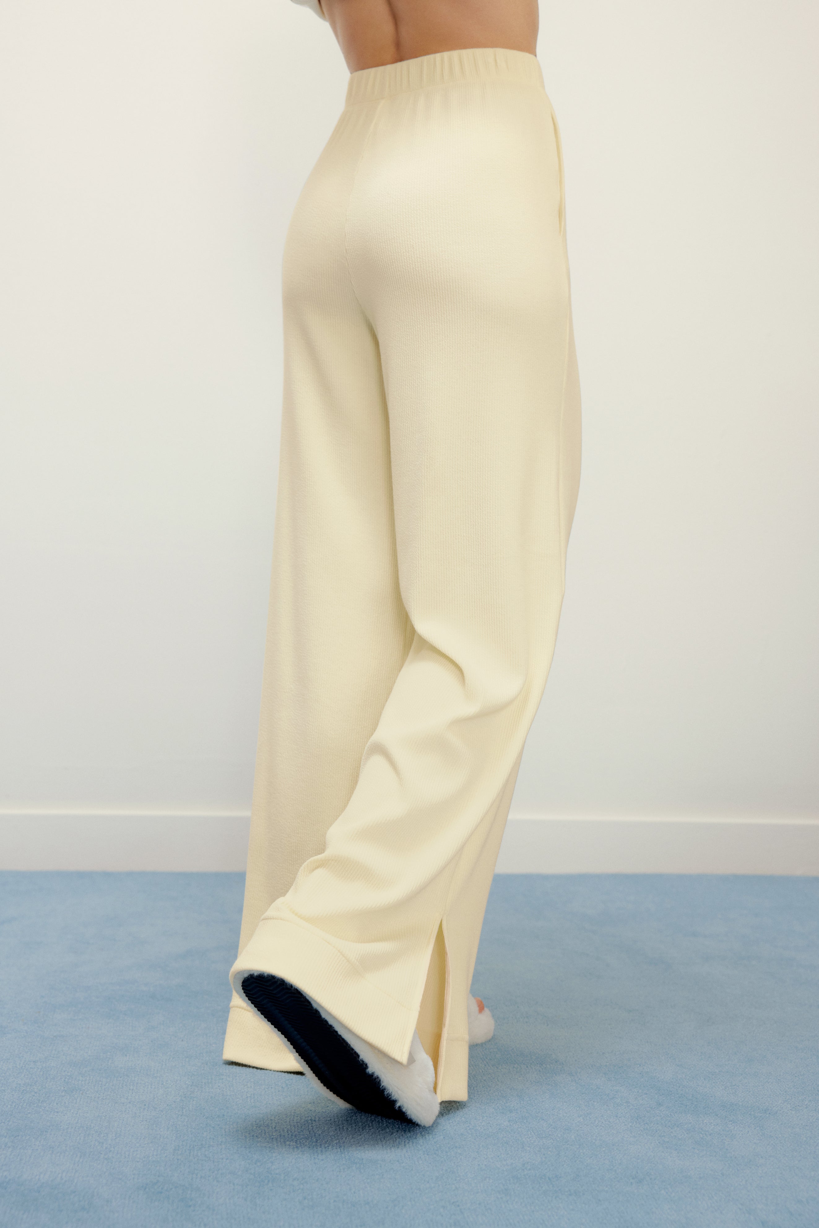 woman in yellow pajama pants from back