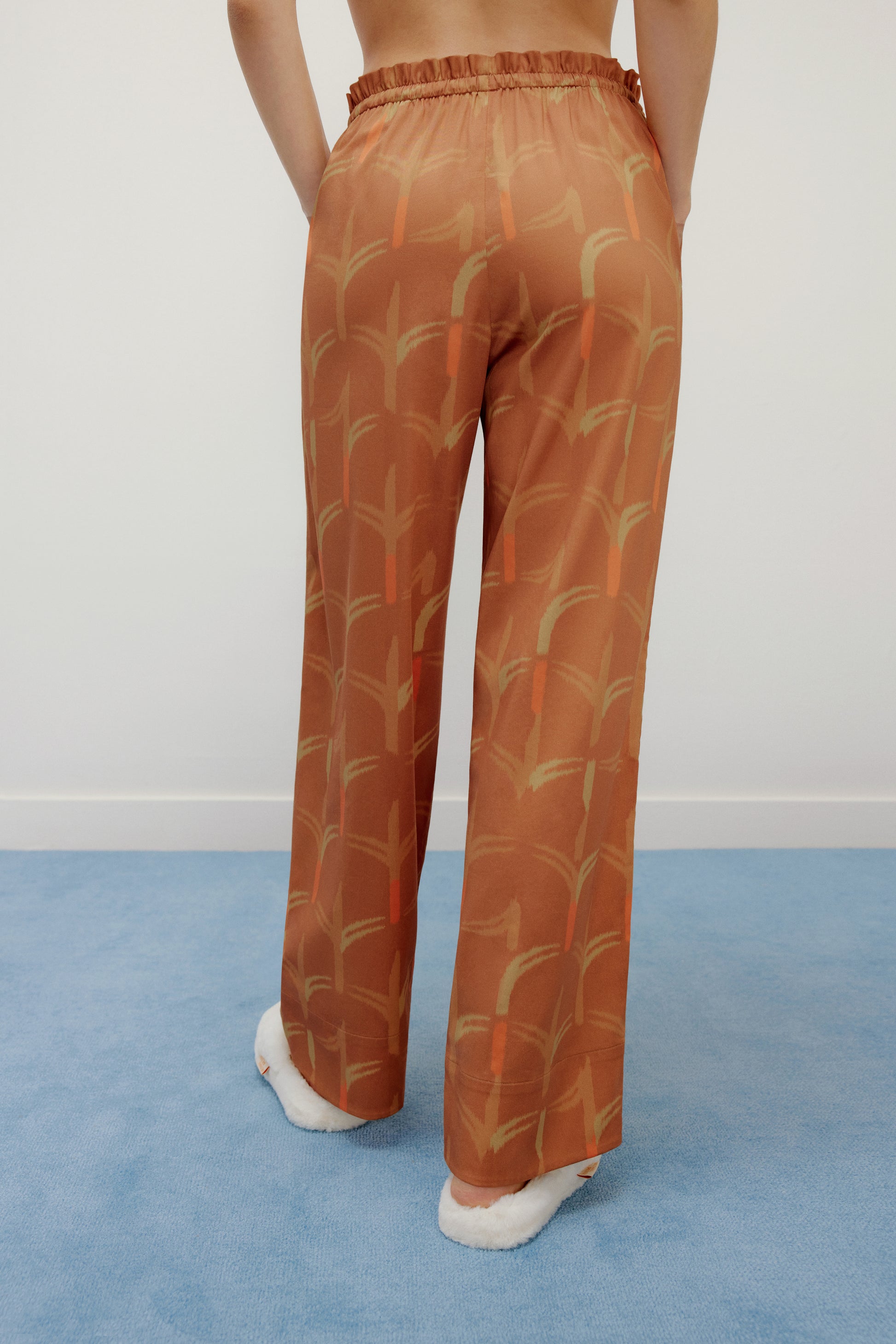 the back of model wearing brown pajama pants