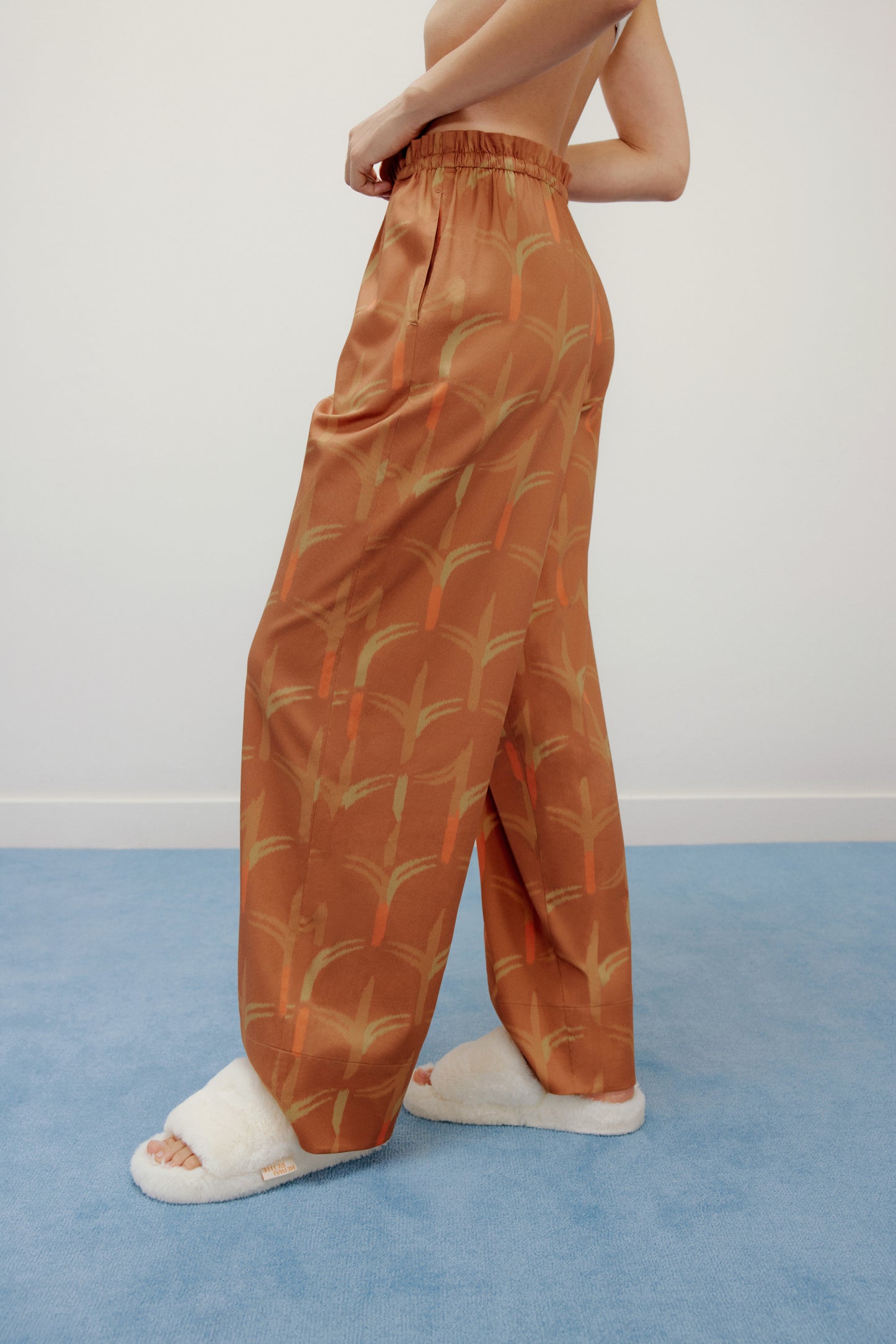 the side of woman wearing brown pajama pants