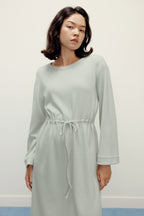 woman in mint pajama longe sleeve dress with waist drawstring