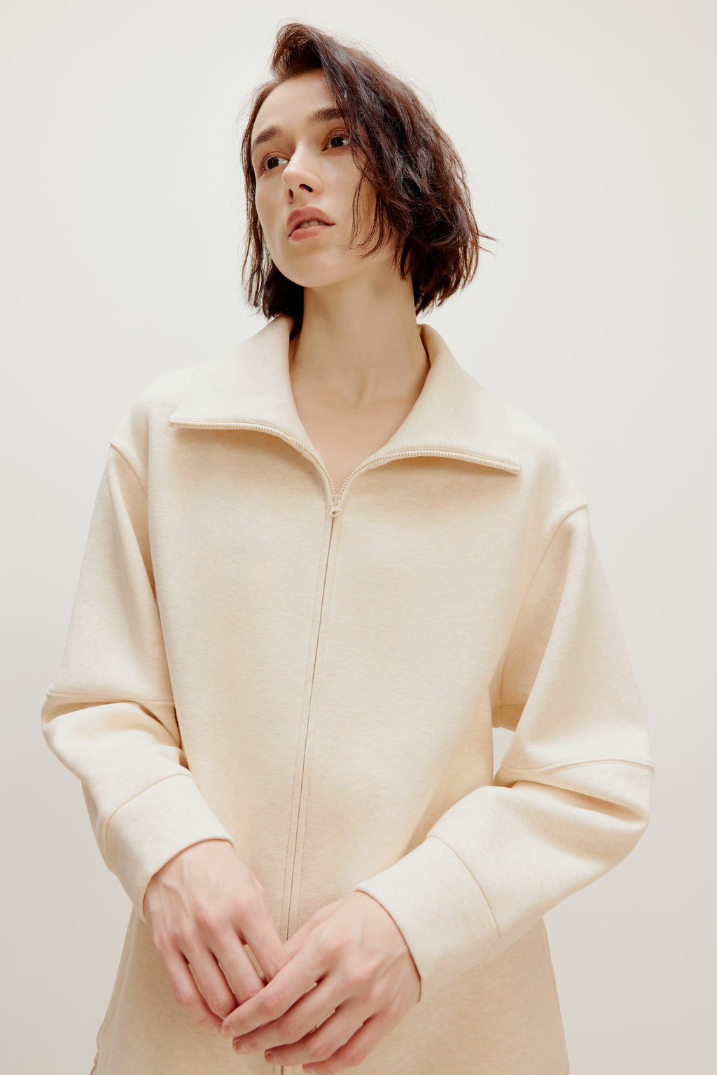 woman with off white zip up jacket