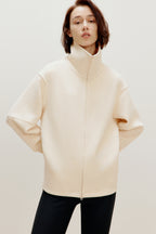 woman with off white zip-up jacket