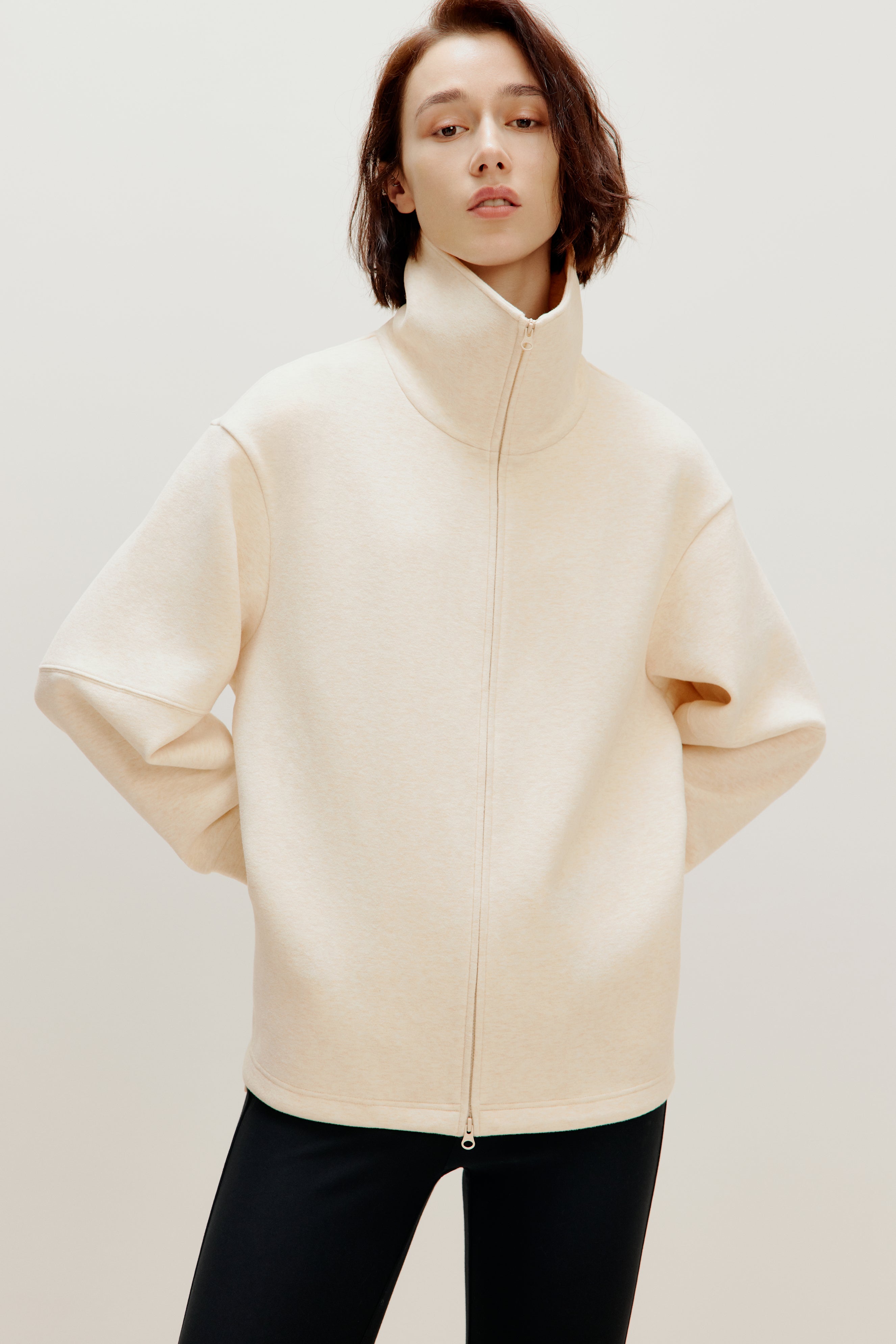 woman with off white zip-up jacket