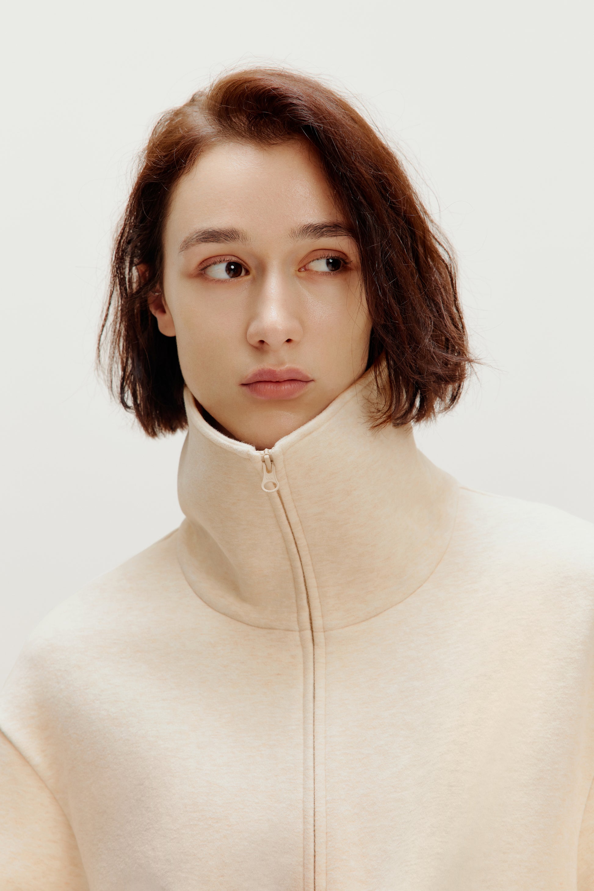 woman with off white turtle neck zip-up jacket 