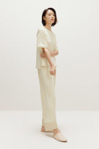 woman in cream pajama t-shirt and matching pants