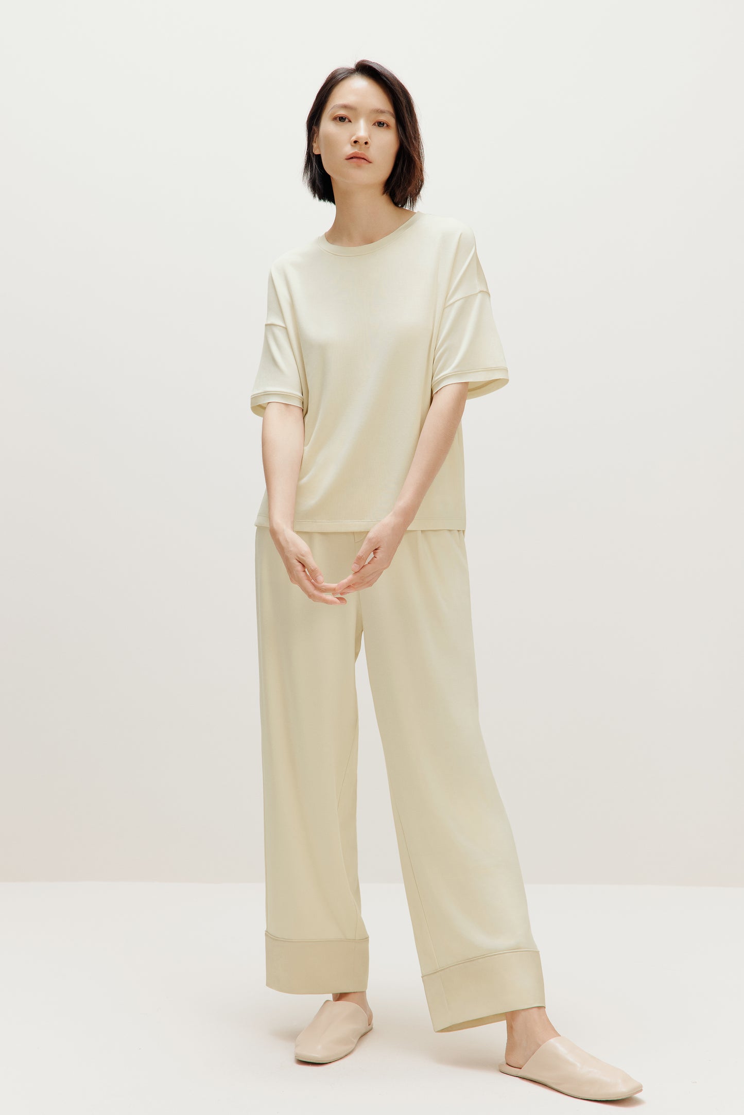 woman in cream pajama t-shirt and matching pants
