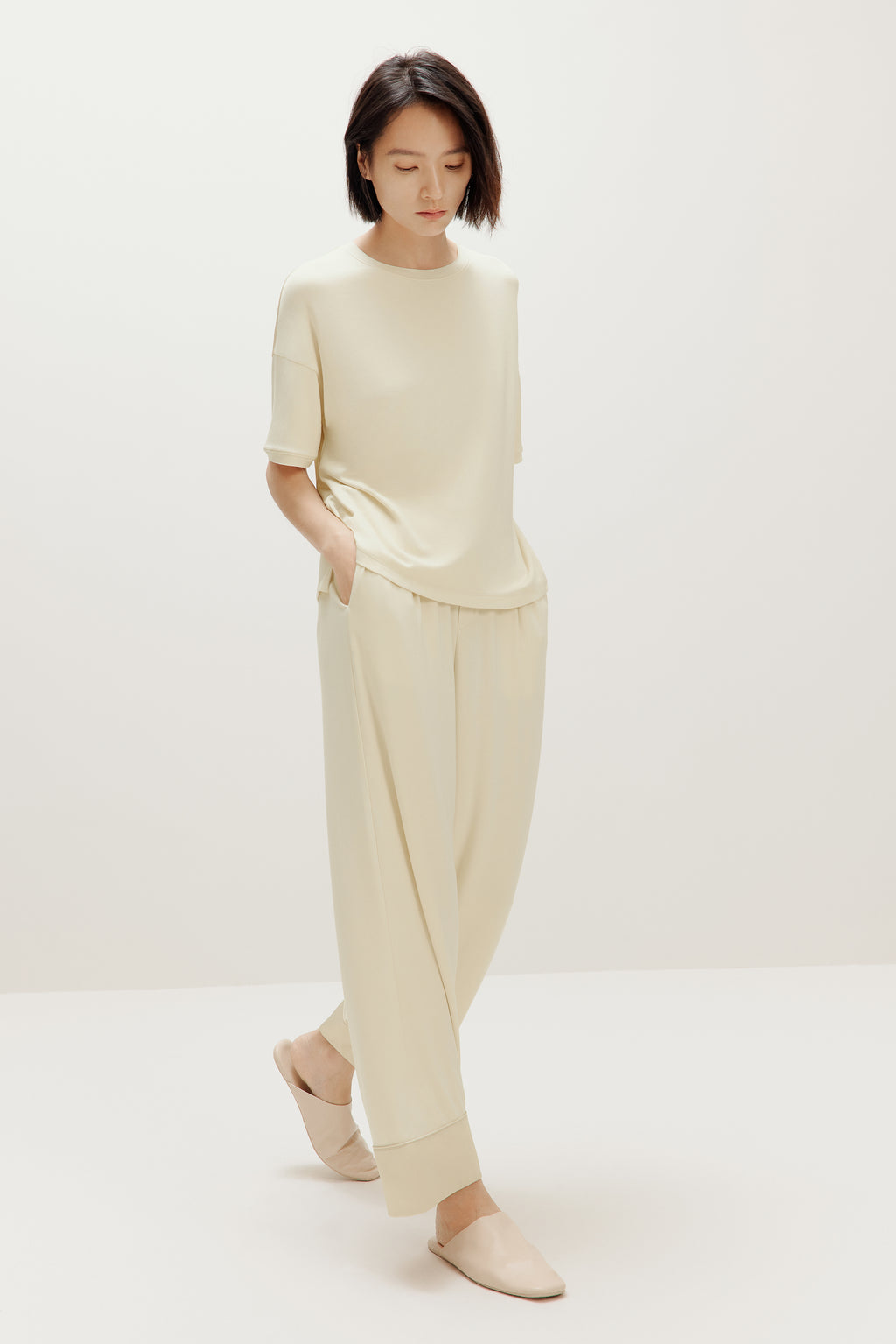 woman in cream pajama t-shirt and matching pants