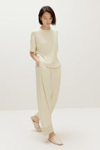 woman in cream pajama t-shirt and matching pants
