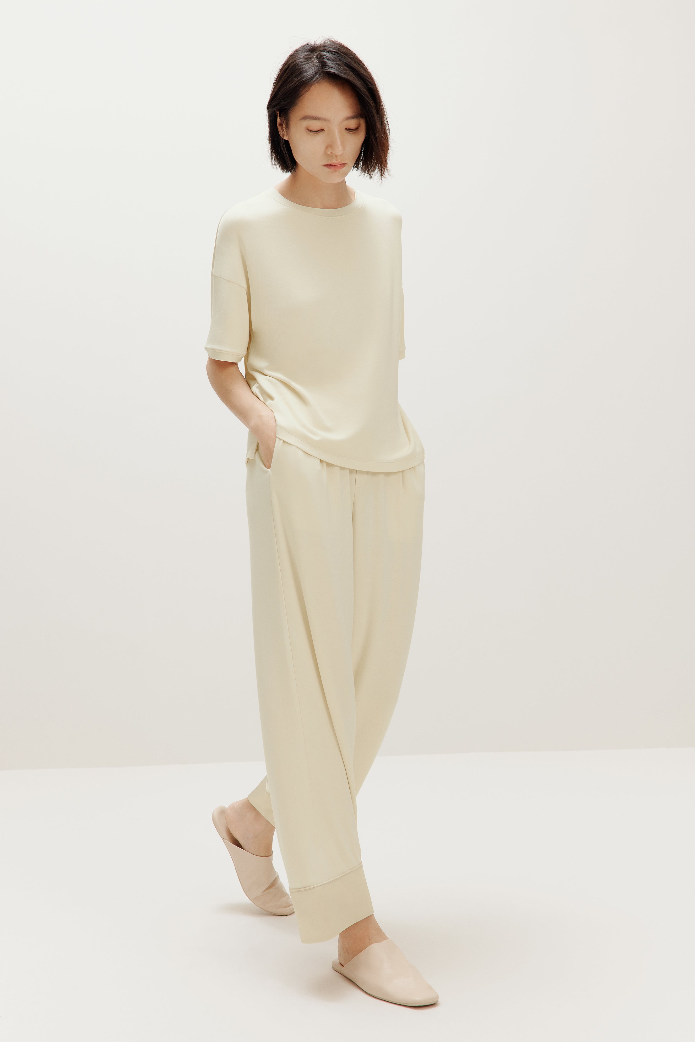 woman in cream pajama t-shirt and matching pants