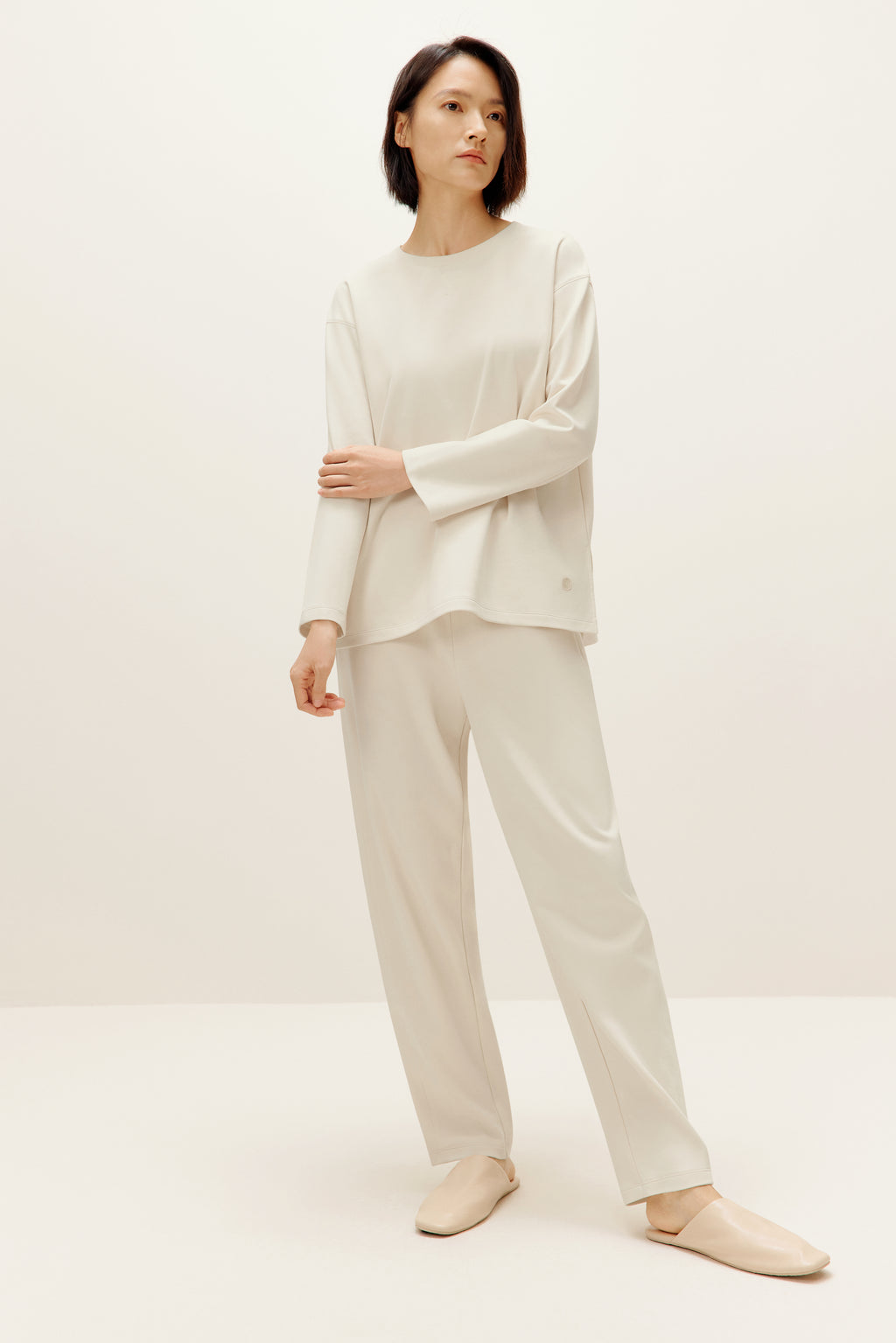 woman with cream color pull over top and pants