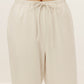 a close look of the waist of a pair of cream color pants with drawstring 