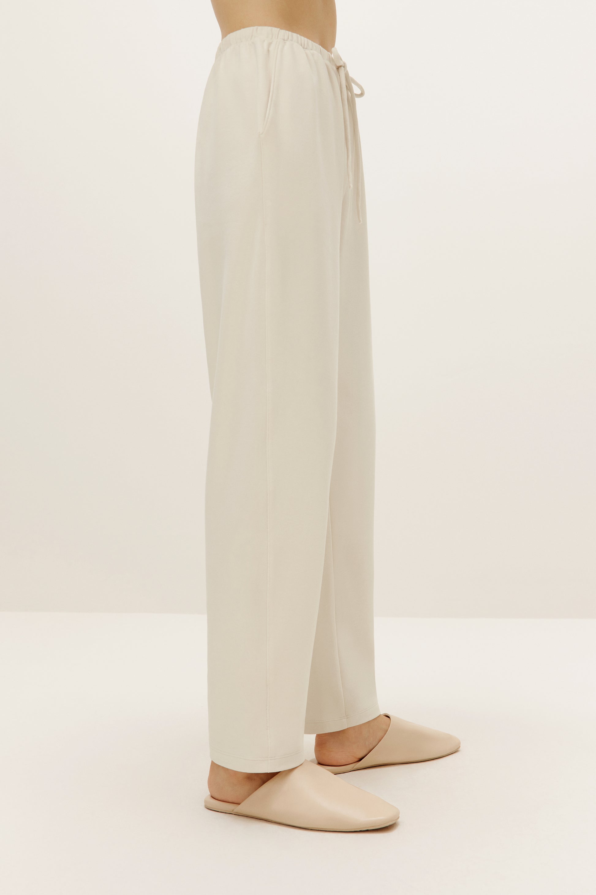 a pair of cream color pants from side