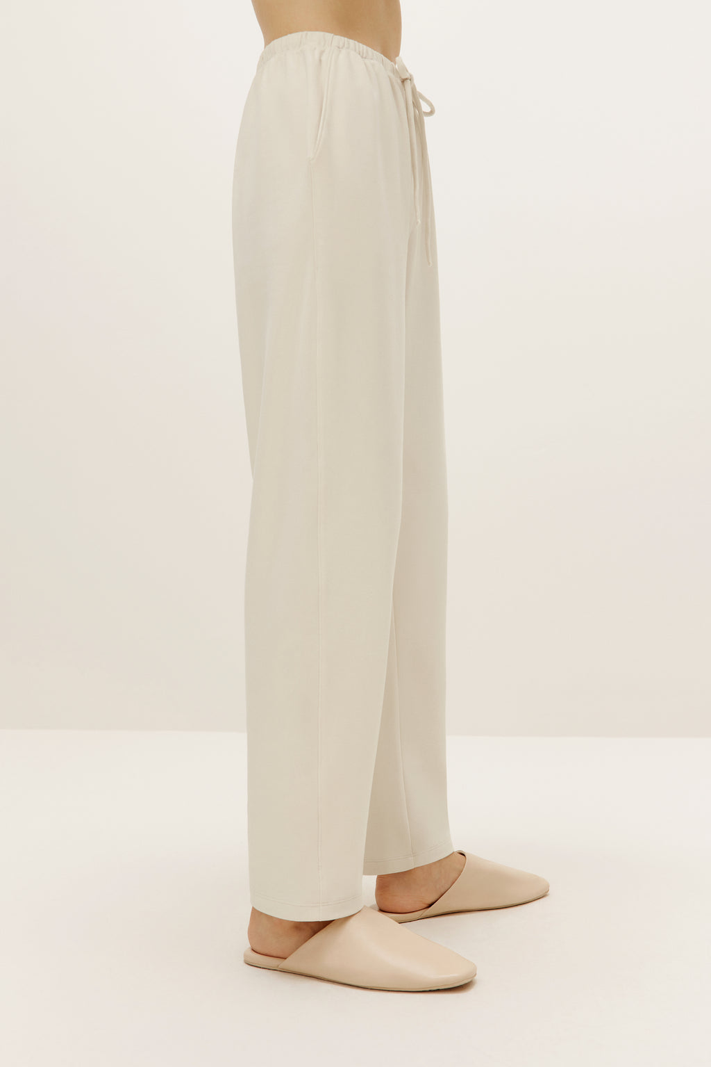 a pair of cream color pants from side
