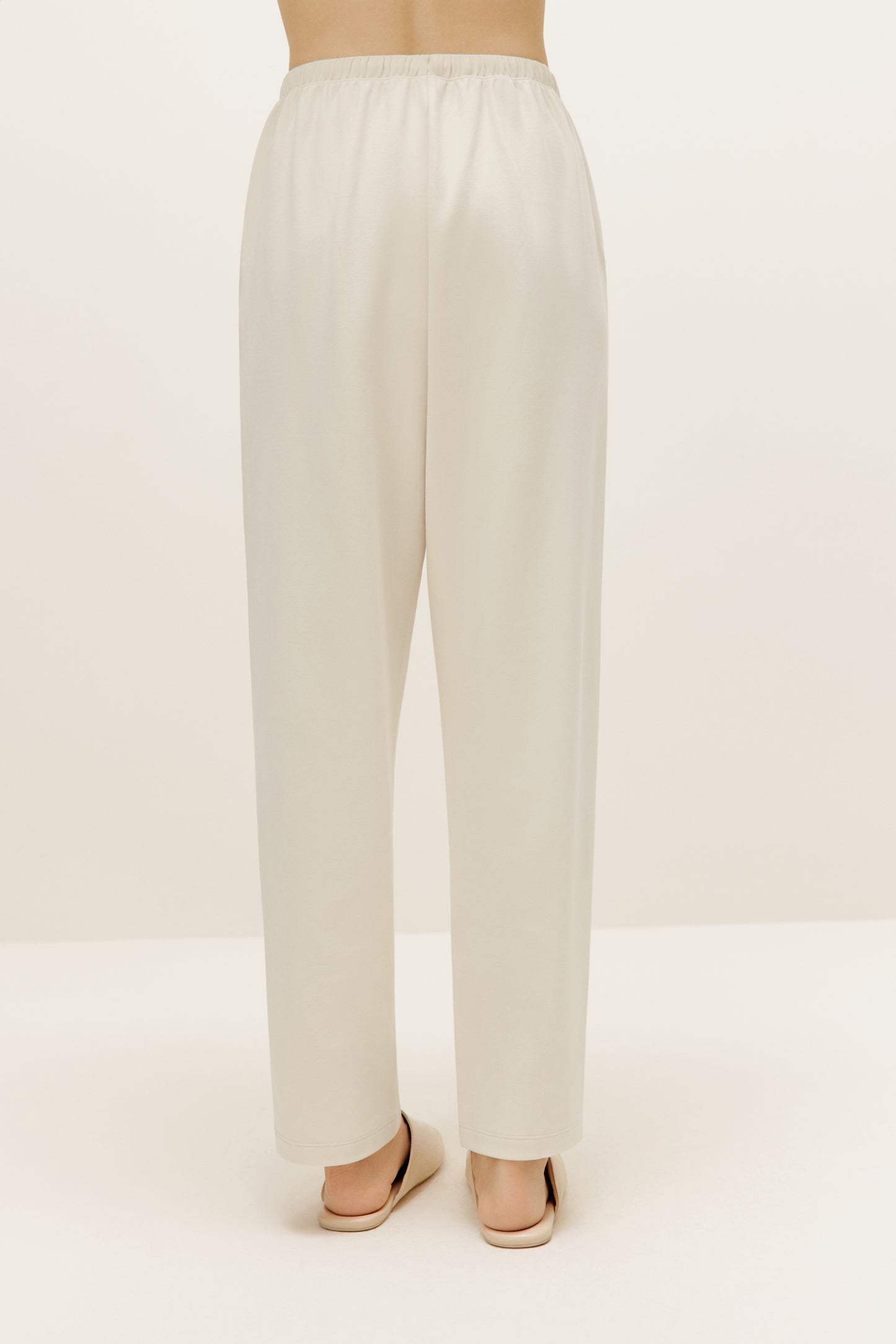 a pair of cream color pants  from back