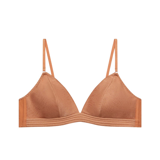 flat lay image of tanned orange bra