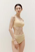 woman wearing light yellow bra and matching panties