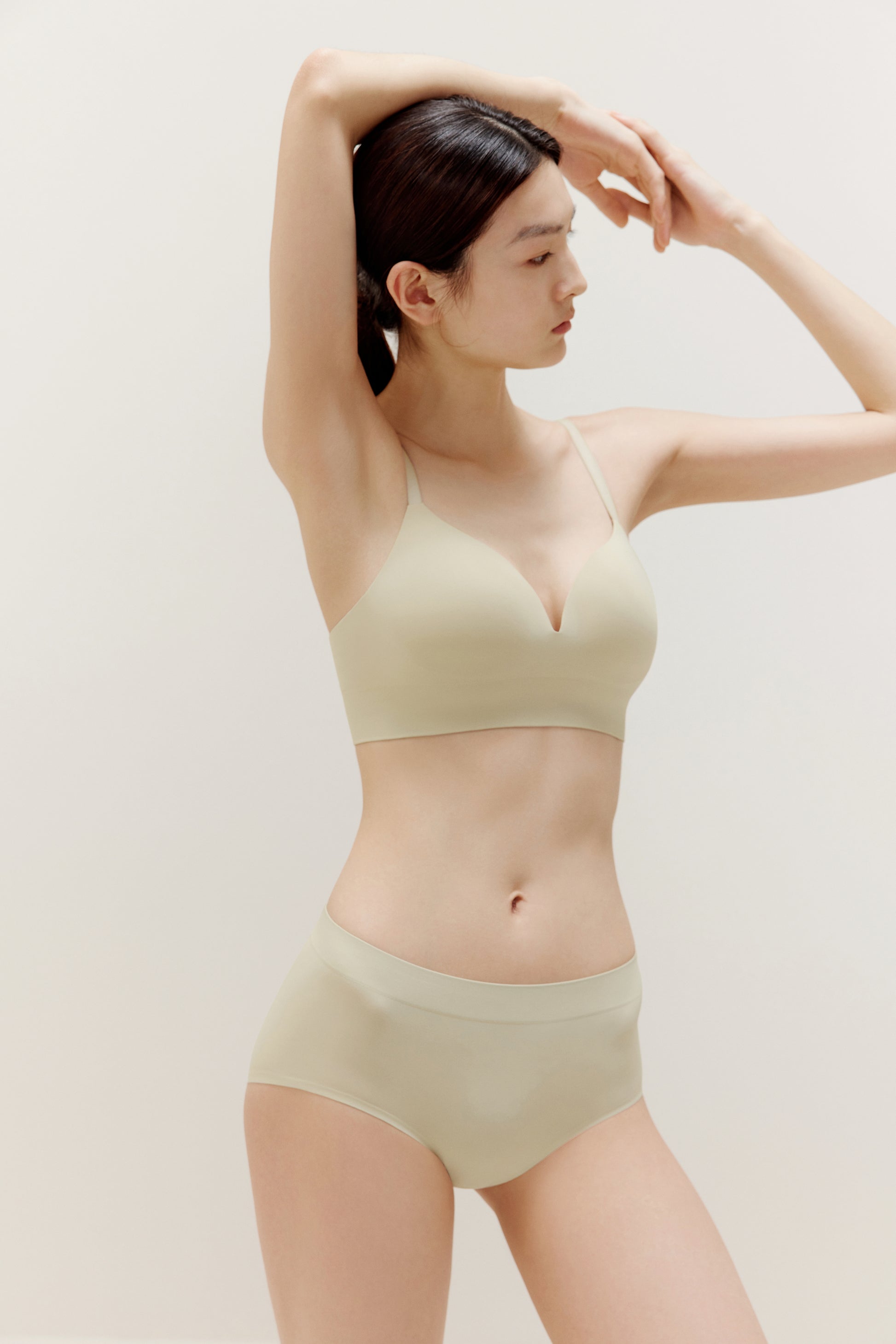a woman wearing a set of cream color underwear 