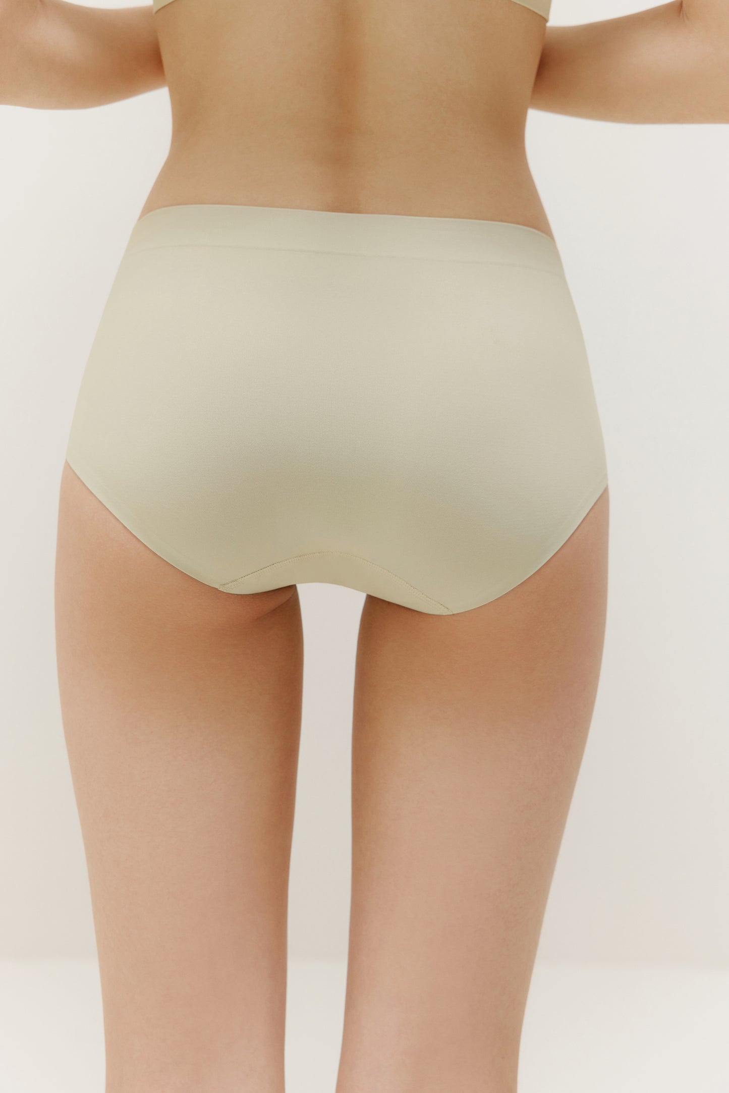 the back of a pair of cream color panties on a woman