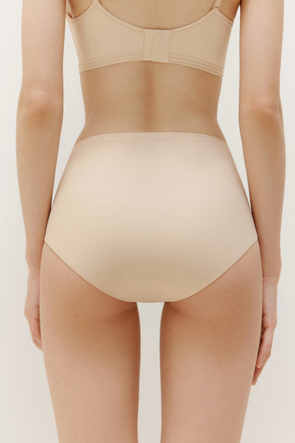 back of woman in beige brief