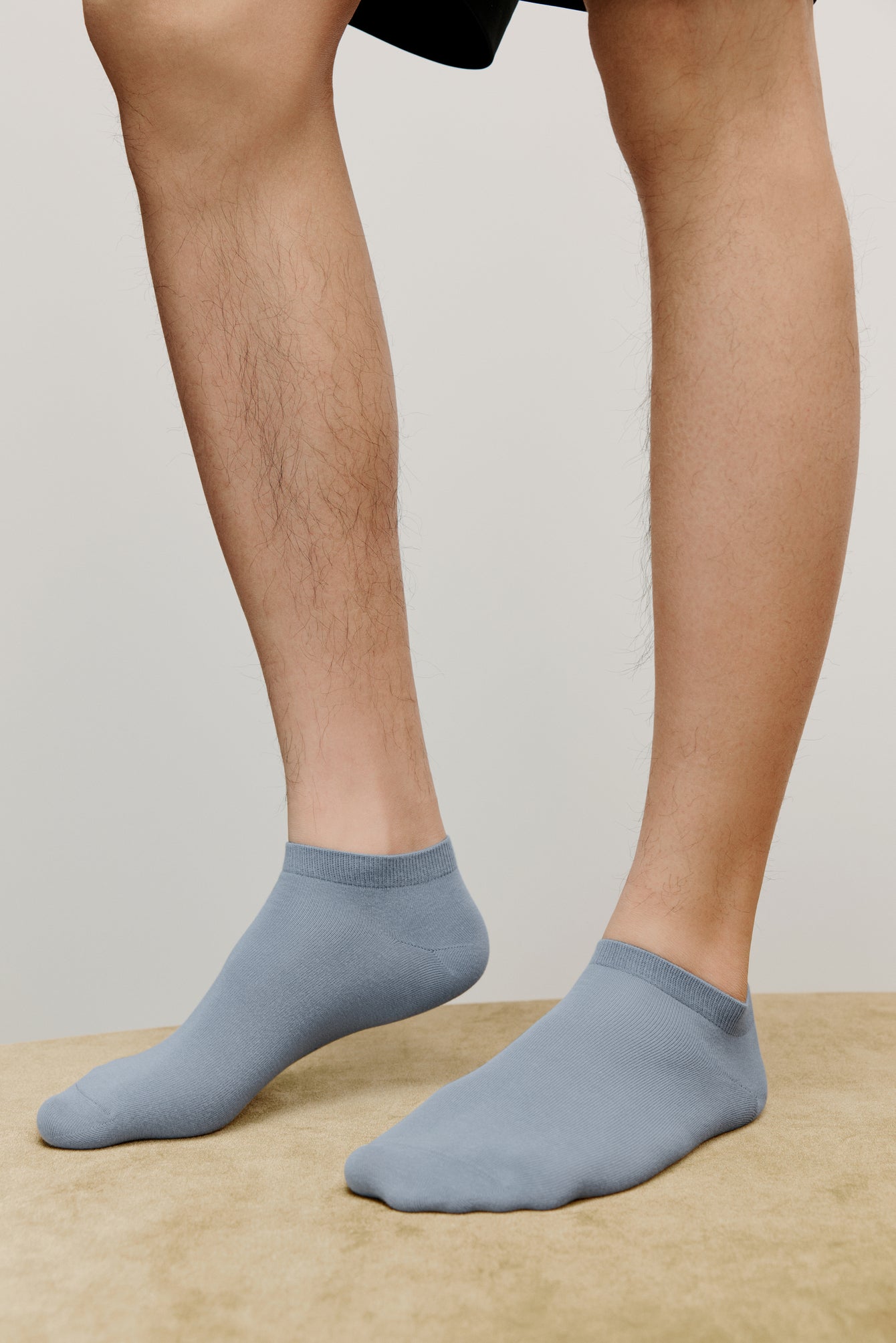 a person wearing blue ankle socks