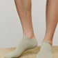 a person wearing green ankle socks