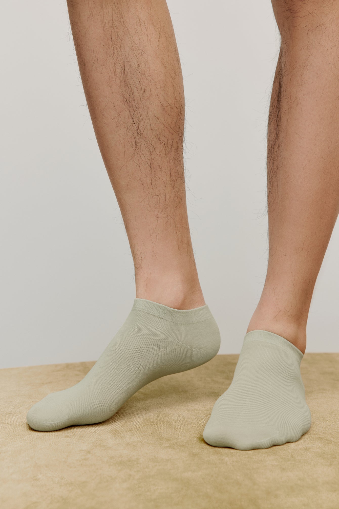 a person wearing green ankle socks