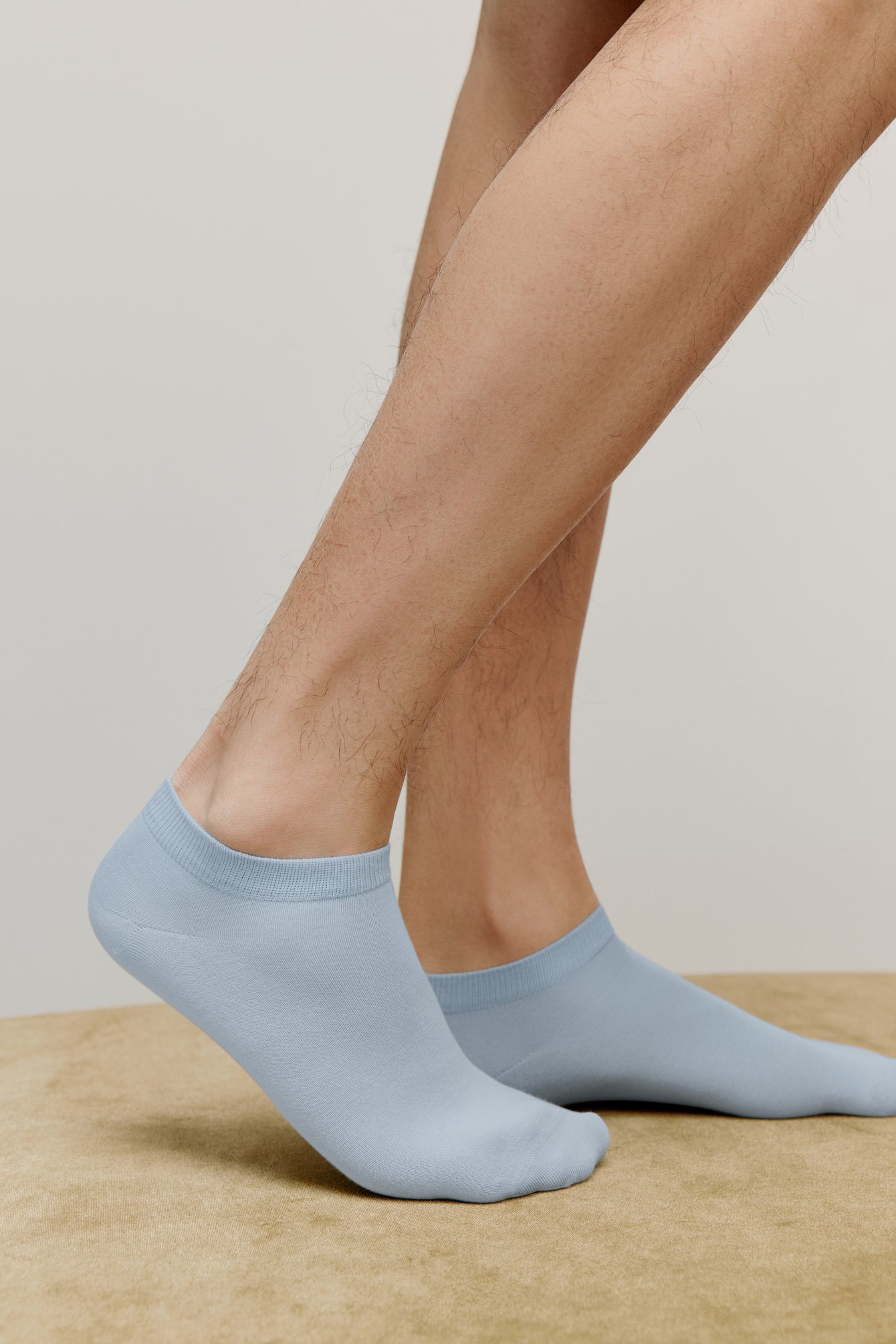 side view of a person wearing blue ankle socks