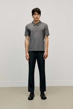 Man in grey polo shirt