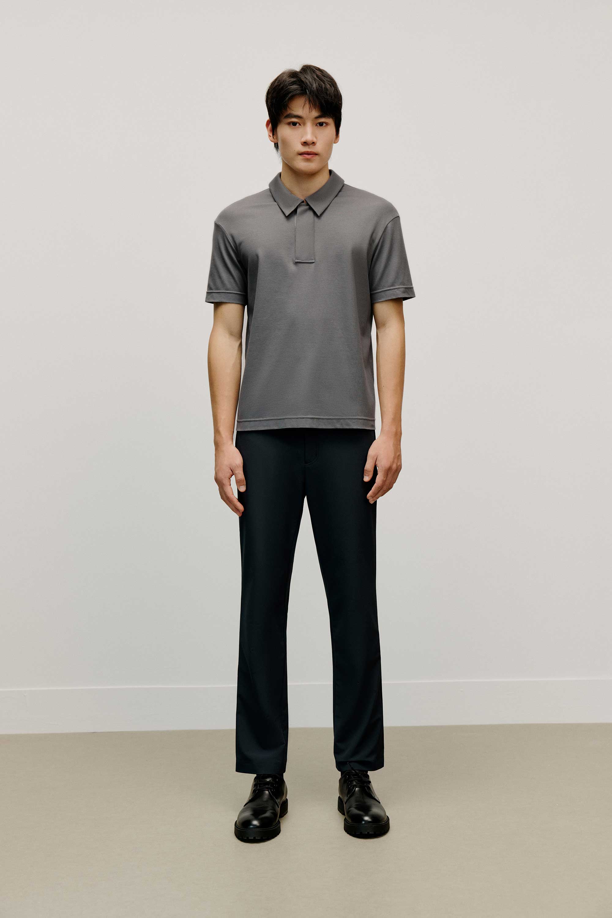 Man in grey polo shirt
