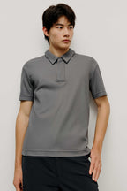 Man in grey polo shirt