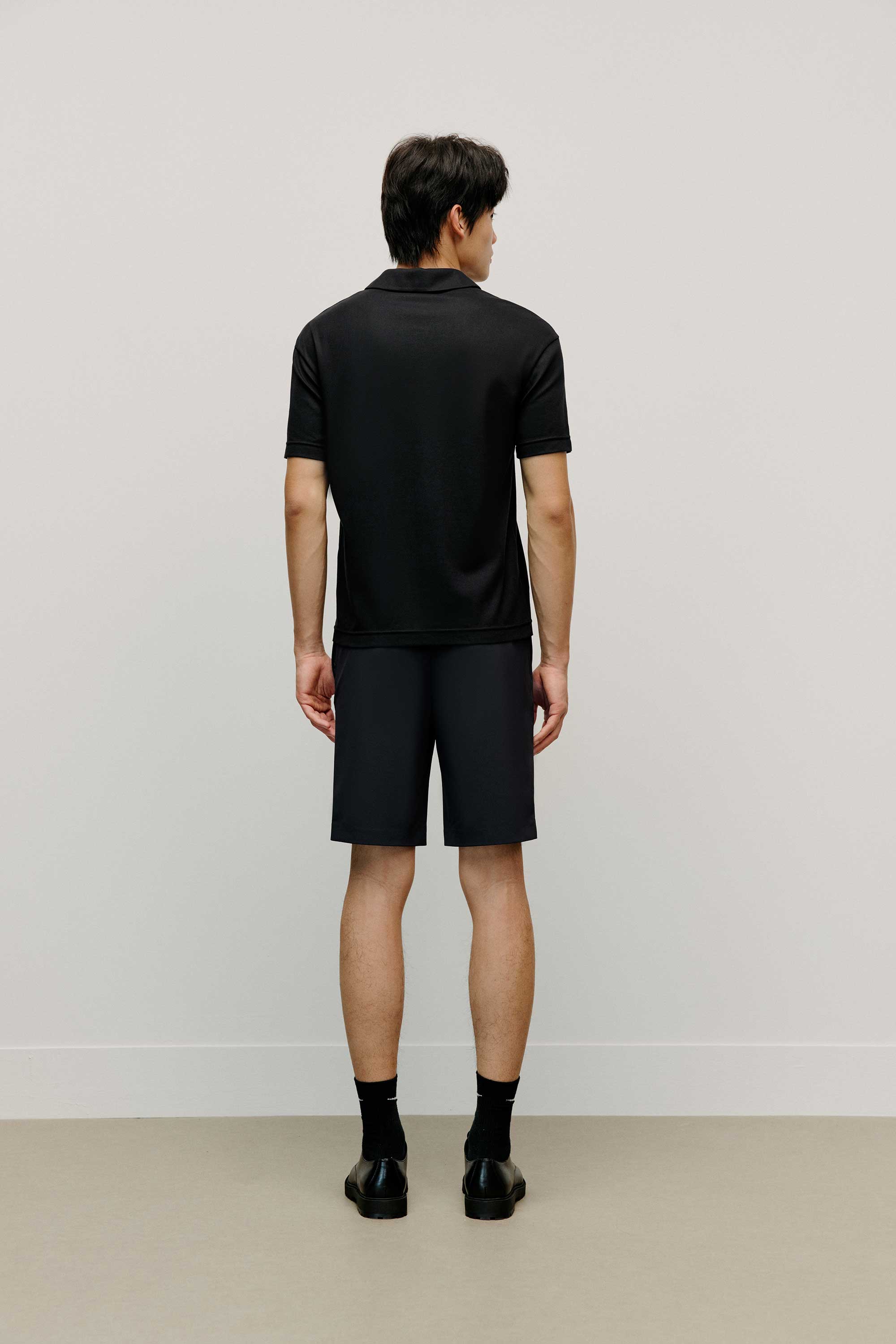 back of black polo shirt