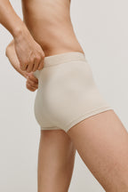 side of man in beige brief