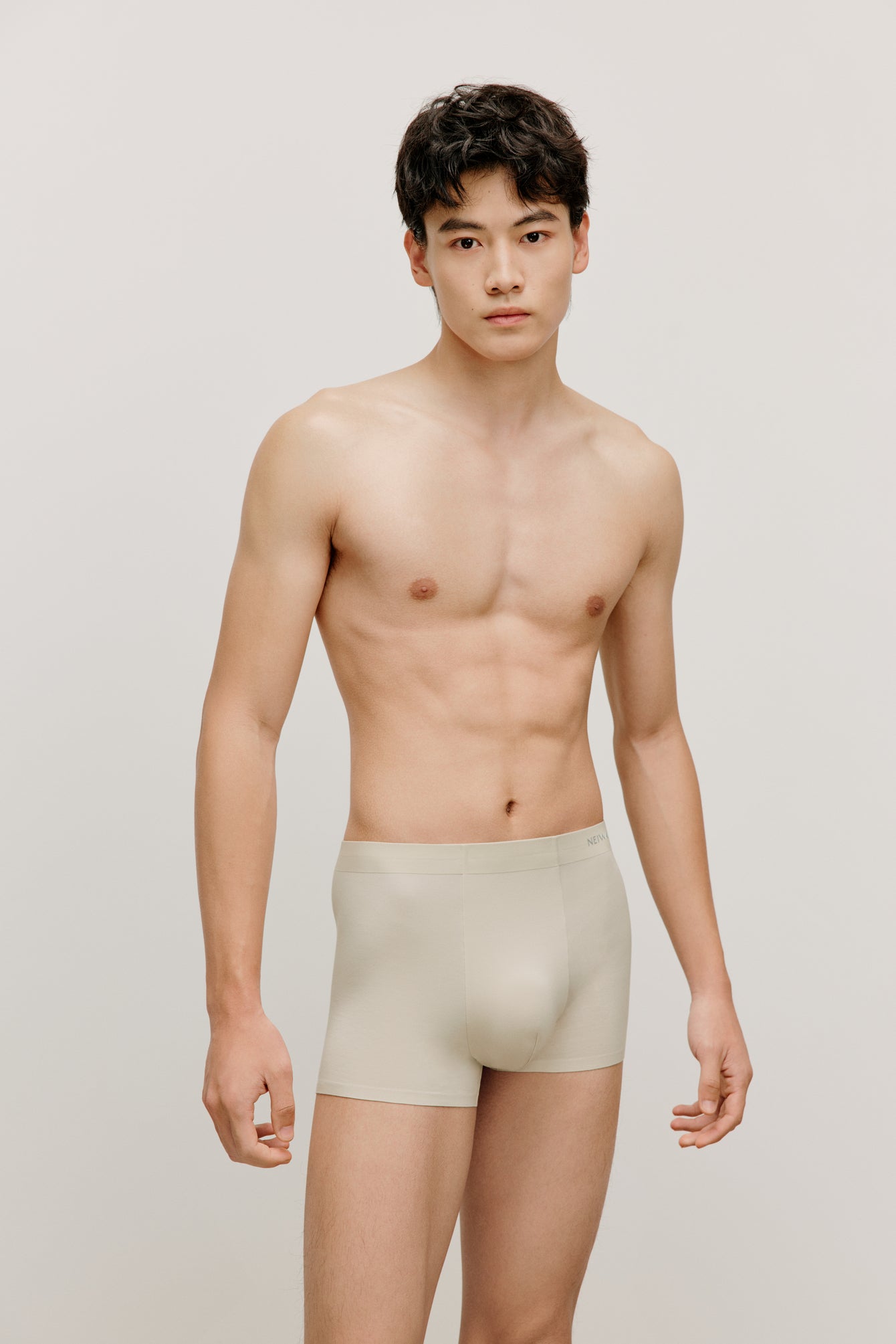 a man wearing a cream brief