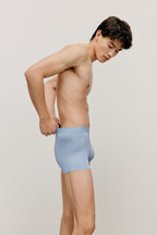 side of a man a man wearing a blue brief