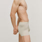 side of a man wearing a cream brief