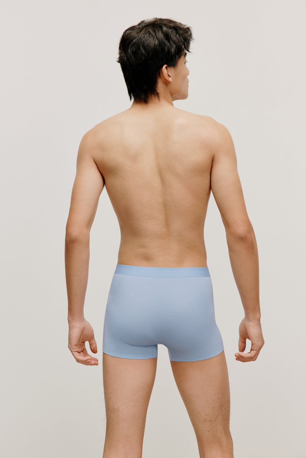 back of a man wearing a blue brief