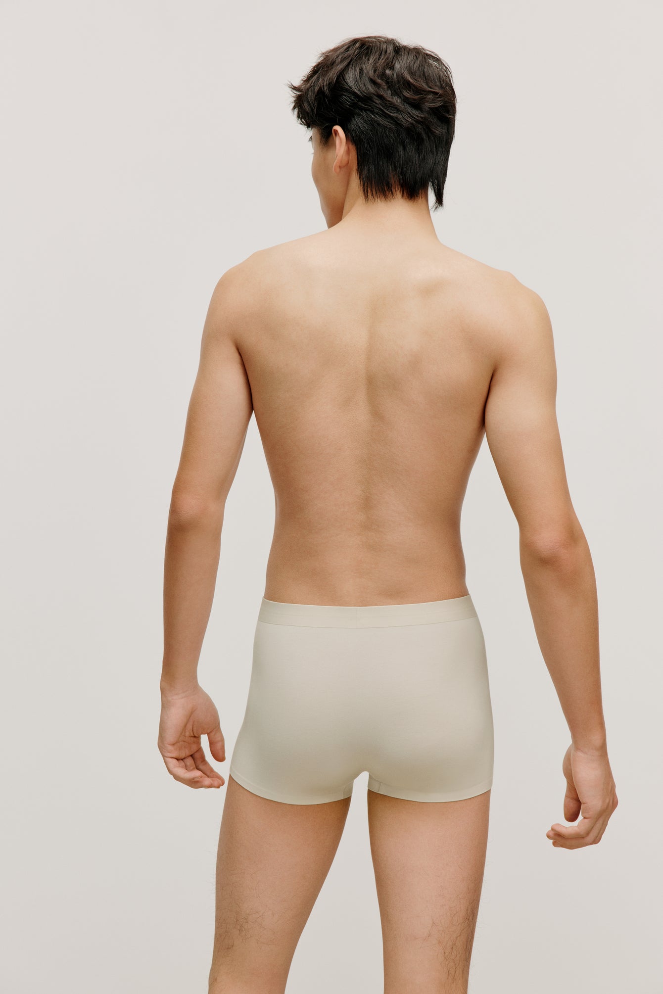 back of a man wearing a cream brief