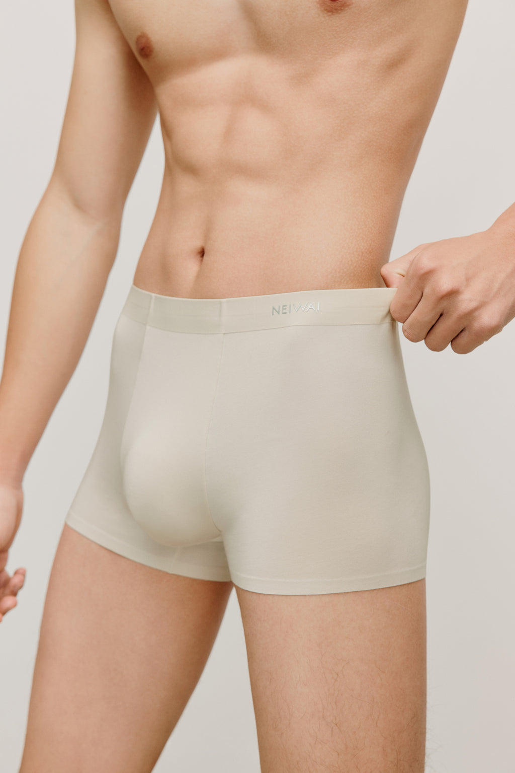 a man wearing a cream brief