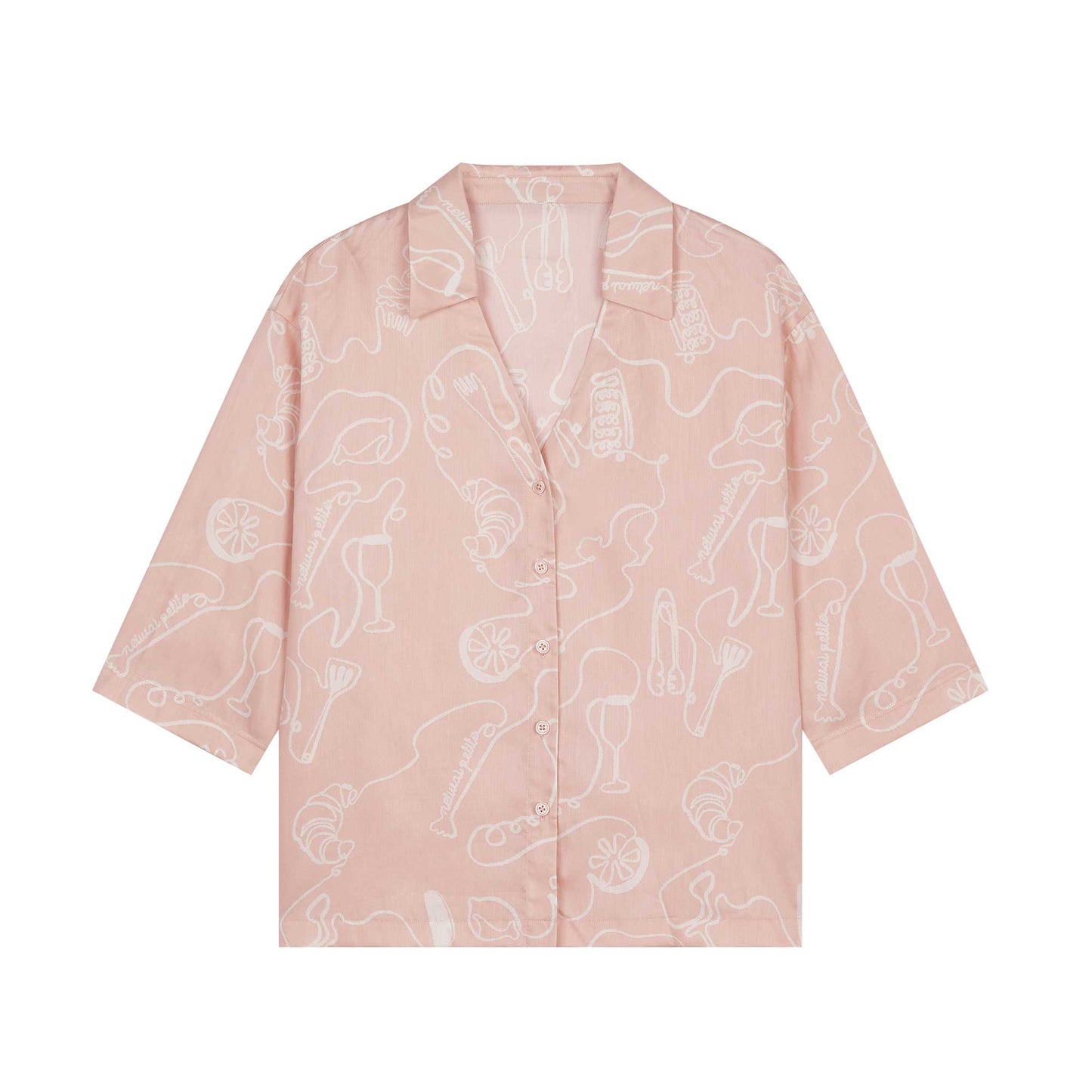 flay lay of pink pajama shirt with white sketches